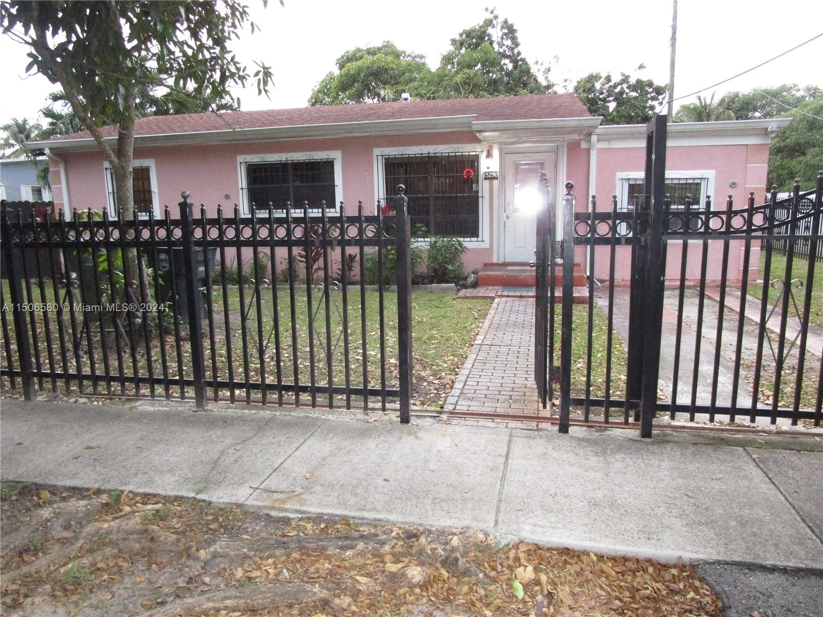 a view of a house with a wooden fence