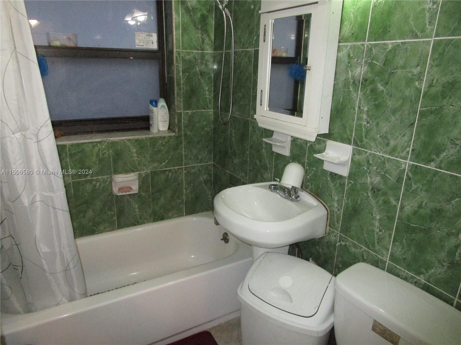 Westside North Miami, FL 33168 - Photo 11 of 13 a bathroom with a sink toilet and shower