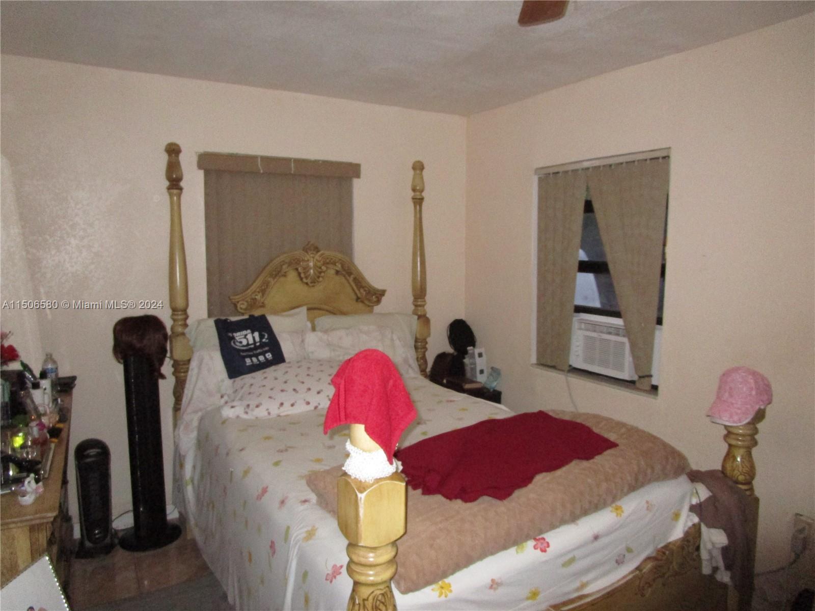 Westside North Miami, FL 33168 - Photo 5 of 13 a bedroom with furniture and a mirror