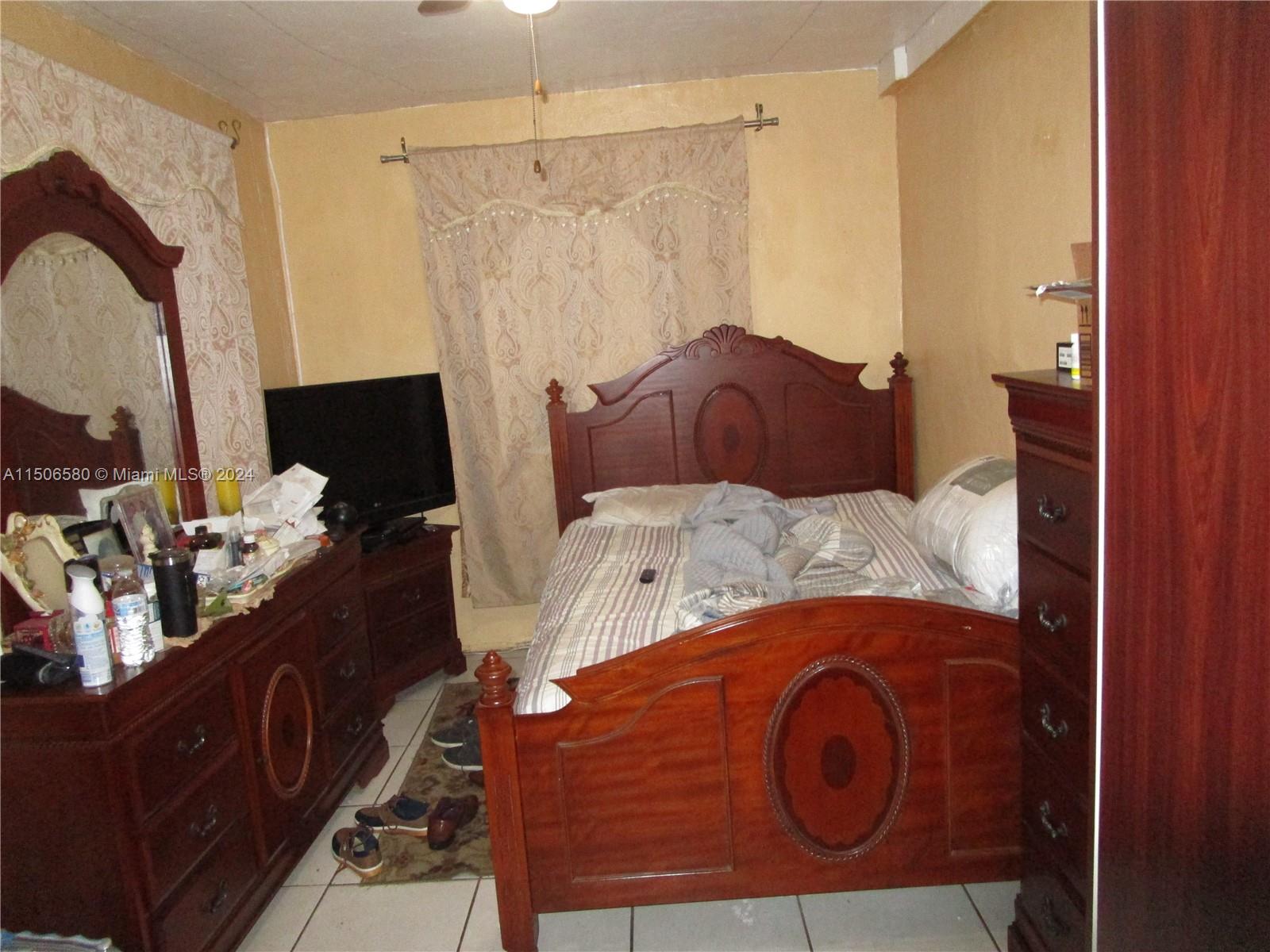 Westside North Miami, FL 33168 - Photo 6 of 13 a bedroom with a bed and a mirror