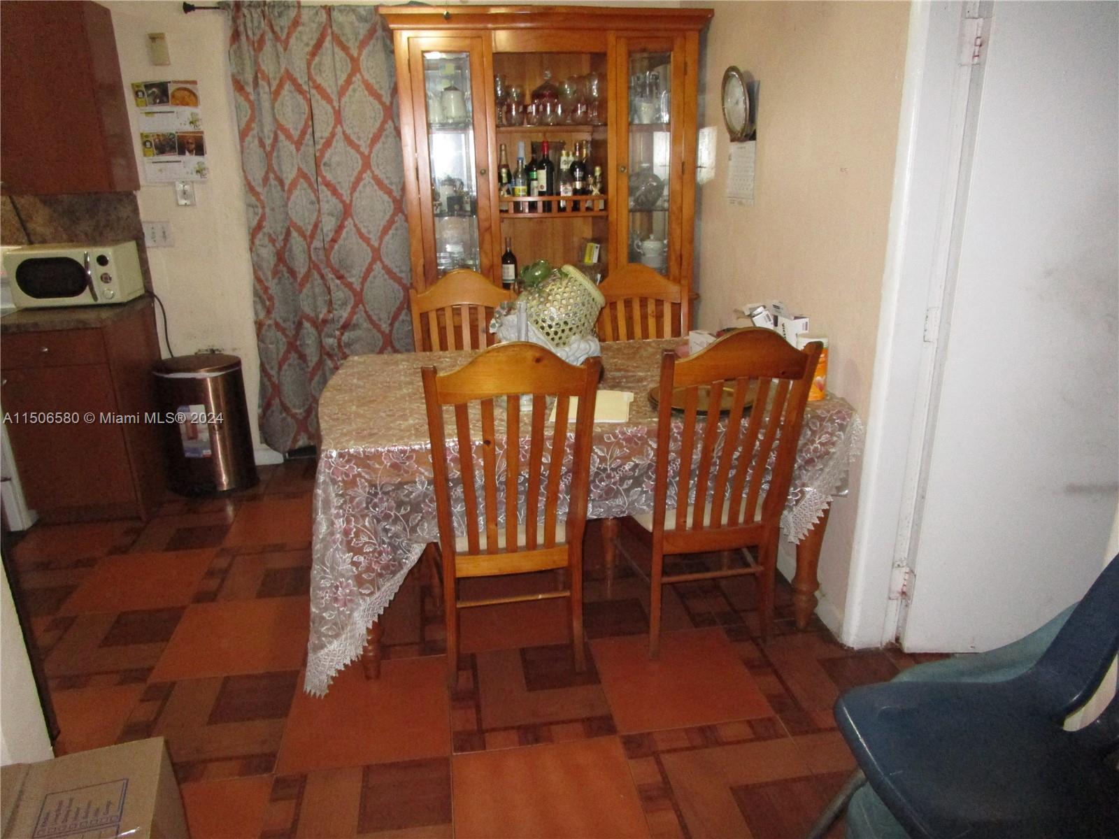 Westside North Miami, FL 33168 - Photo 8 of 13 a view of a dining room with furniture window and wooden floor