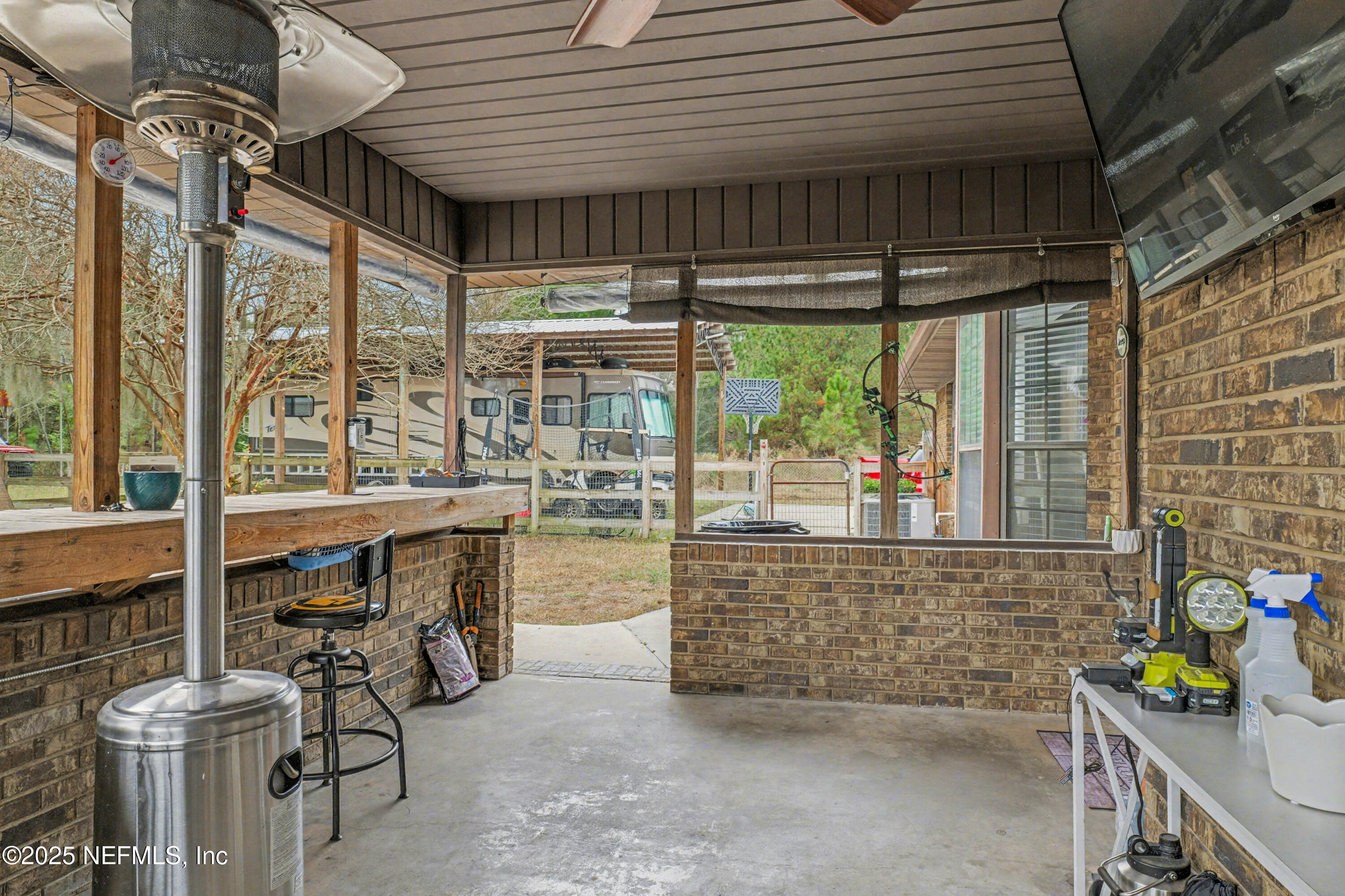 820 Golf Club Road Macclenny, FL 32063 - Photo 12 of 51 a view of a patio with table and chairs potted plants with floor to ceiling window