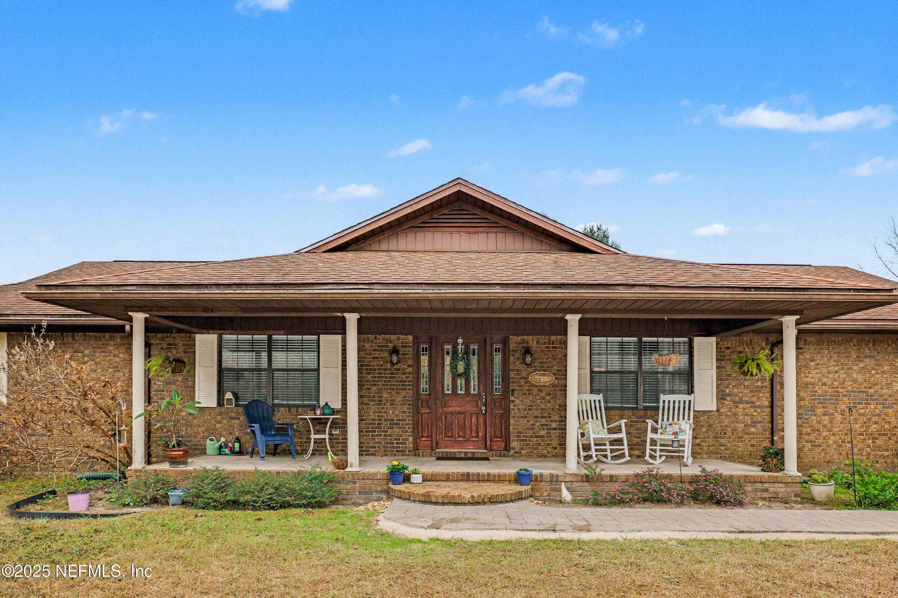 820 Golf Club Road Macclenny, FL 32063 - Photo 2 of 51 a front view of a house with garden