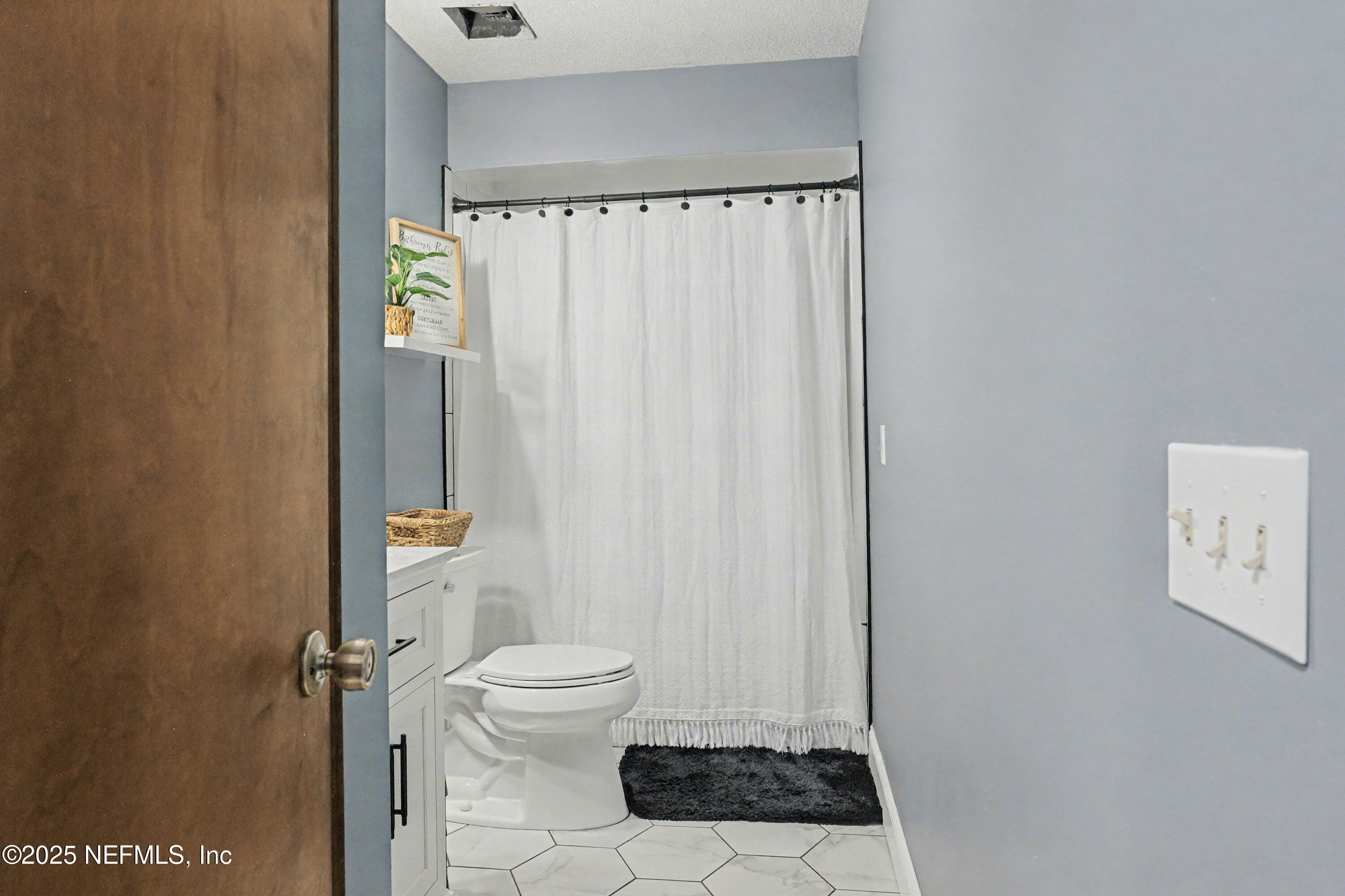 820 Golf Club Road Macclenny, FL 32063 - Photo 21 of 51 a bathroom with a toilet and a shower