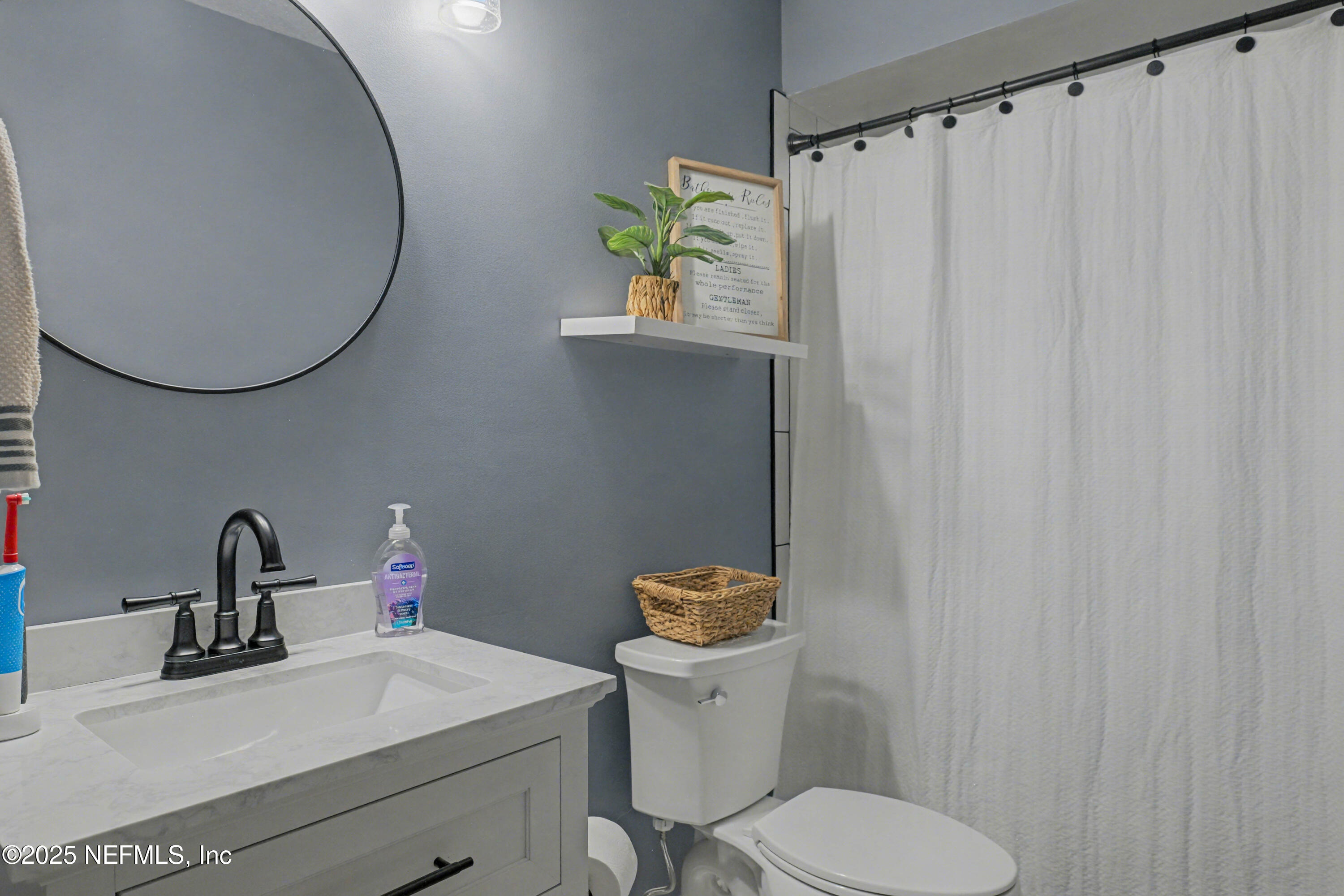 820 Golf Club Road Macclenny, FL 32063 - Photo 22 of 51 a bathroom with a sink mirror and toilet