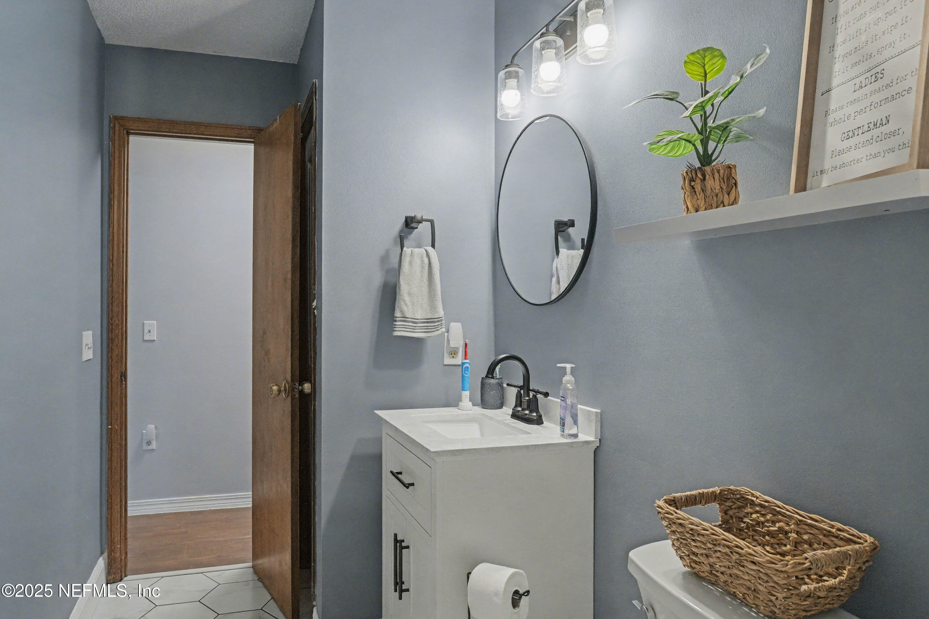 820 Golf Club Road Macclenny, FL 32063 - Photo 23 of 51 a bathroom with a sink and a mirror