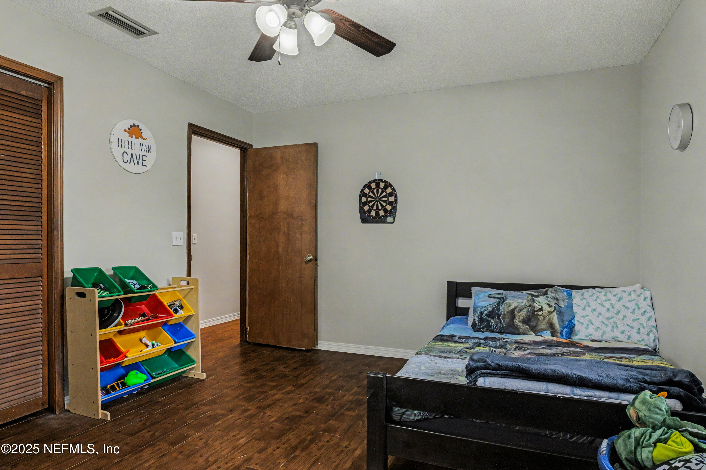 820 Golf Club Road Macclenny, FL 32063 - Photo 28 of 51 a bedroom with bed and painting on the wall