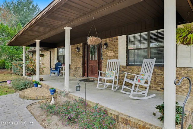 a view of a chairs and table in backyard of the house