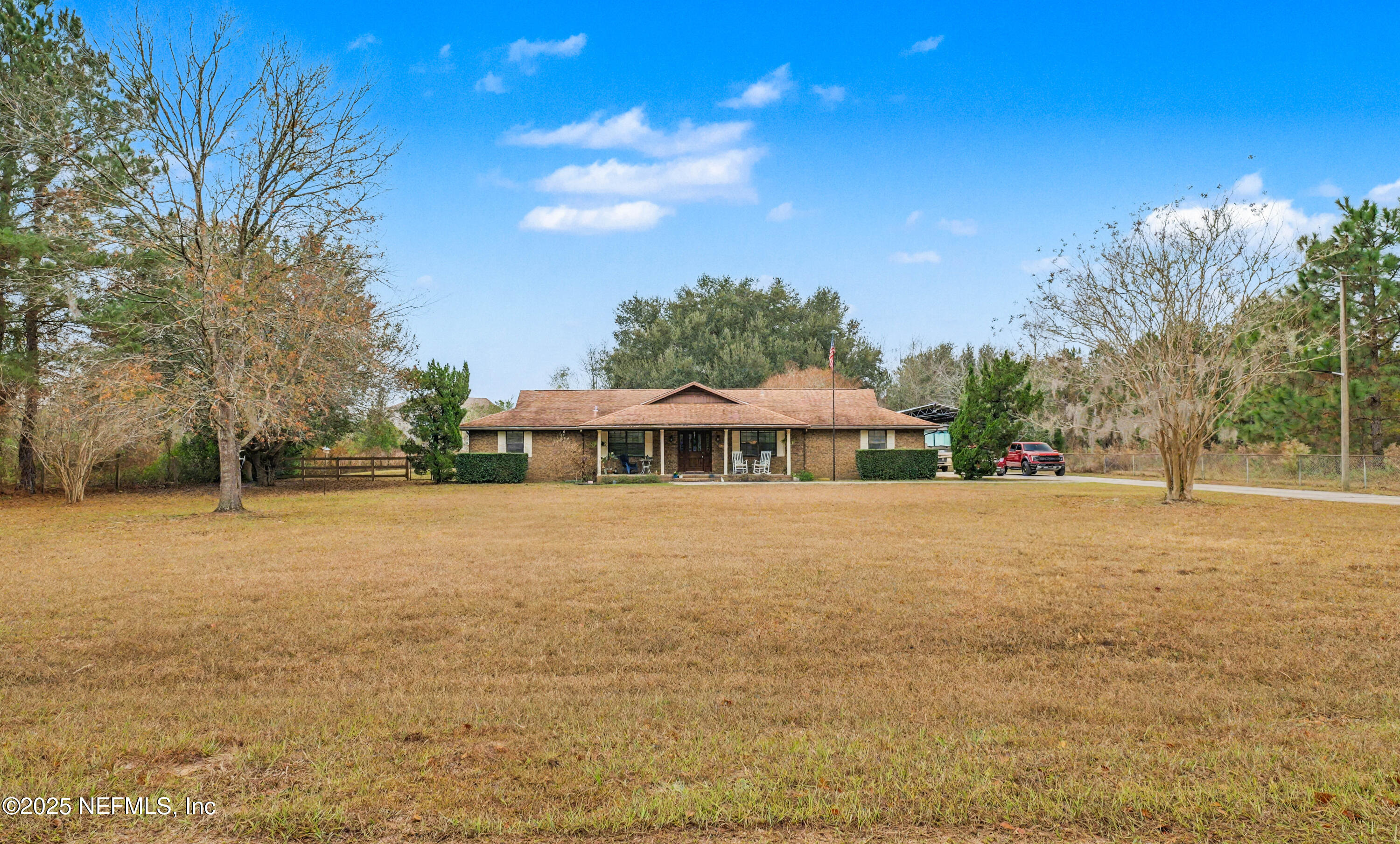 820 Golf Club Road Macclenny, FL 32063 - Photo 4 of 51 a yellow house with trees in front of it
