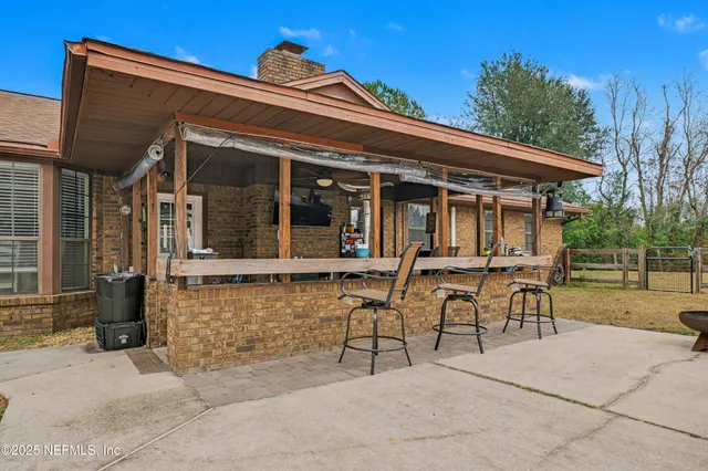 a view of a house with backyard porch and sitting area