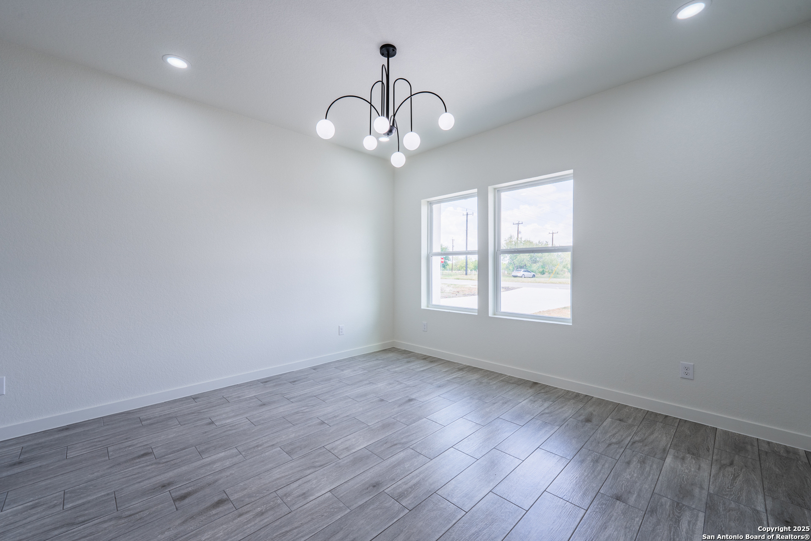 122 Ranchero Way Natalia, TX 78059 - Photo 16 of 31 wooden floor in an empty room with a window