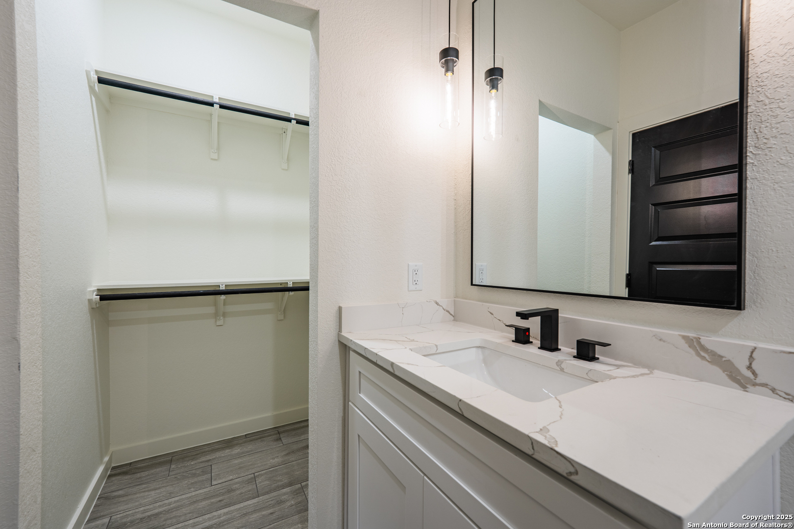 122 Ranchero Way Natalia, TX 78059 - Photo 18 of 31 a bathroom with a sink and a mirror
