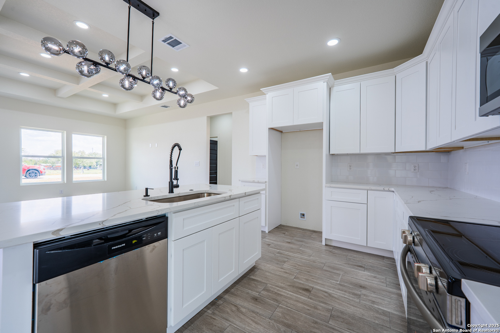 122 Ranchero Way Natalia, TX 78059 - Photo 6 of 31 a kitchen with a sink stove and wooden floor