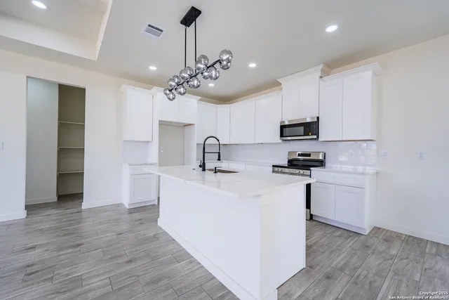 a view of a kitchen with microwave and cabinets
