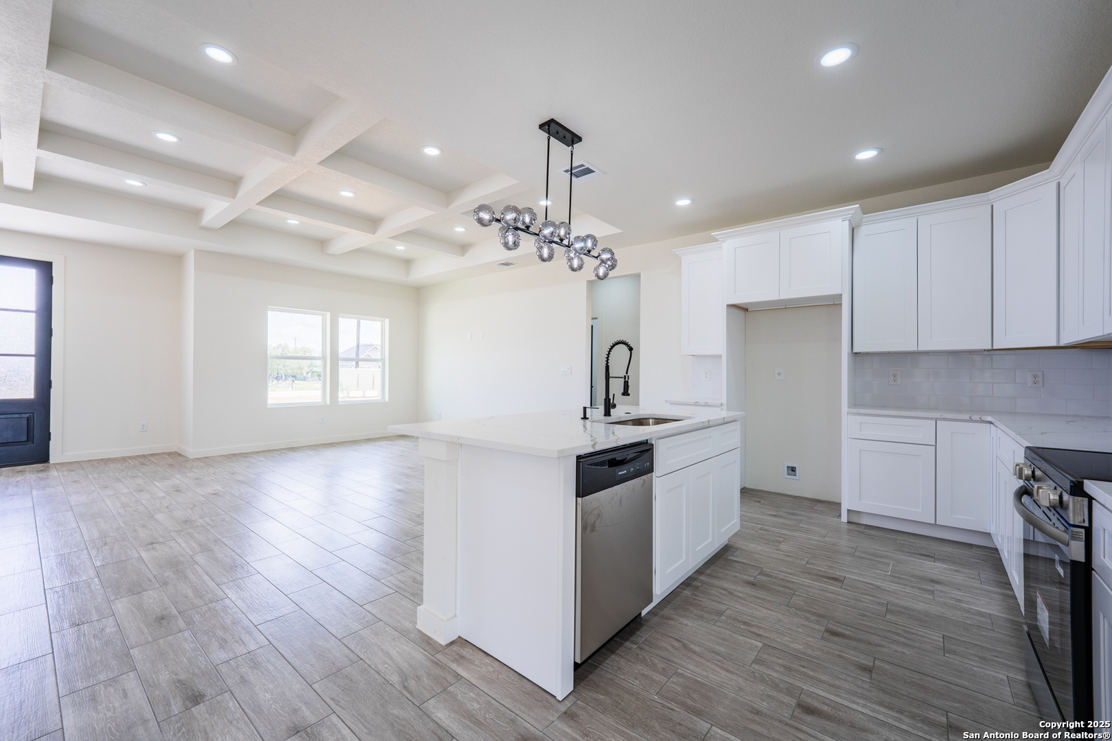 122 Ranchero Way Natalia, TX 78059 - Photo 10 of 31 a kitchen with granite countertop a stove and a refrigerator