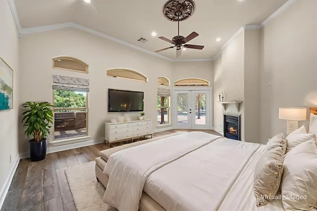 a bedroom with a bed and a chandelier