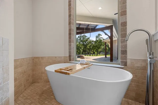 a bath tub sitting in a bathroom next to a window