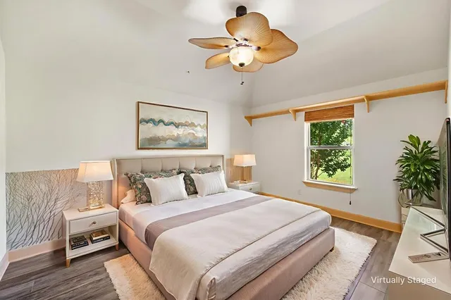 a bedroom with a large bed and a chandelier