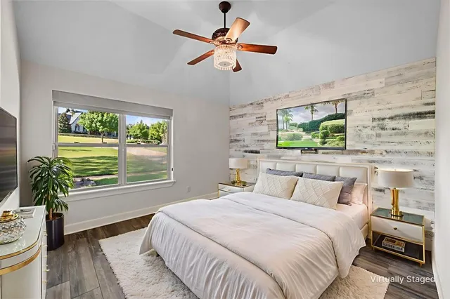 a bedroom with a bed and a large window