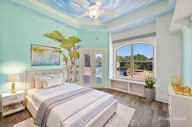 a bedroom with a bed and a chandelier