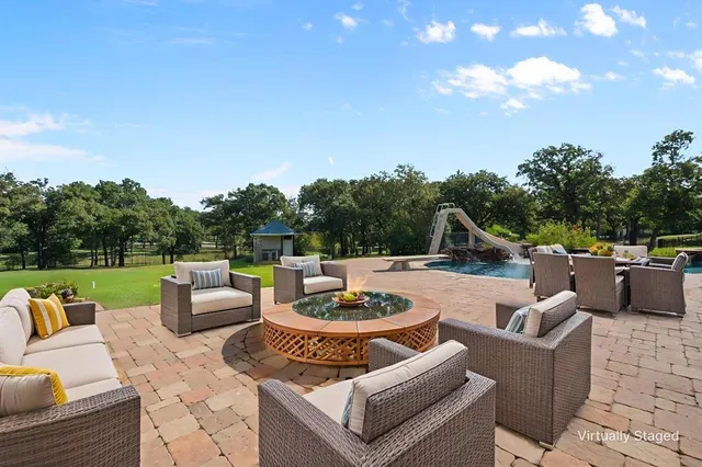 a view of a patio with couches chairs and a fire pit