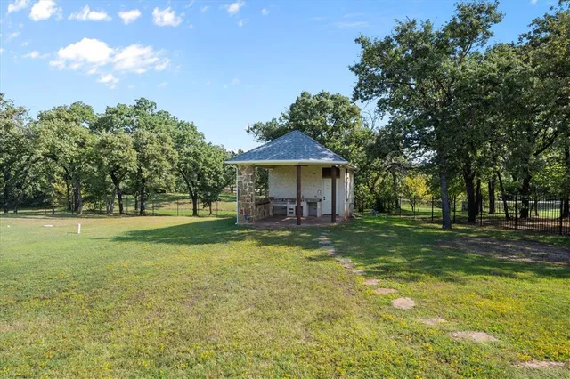 a view of a house with a yard and sitting area