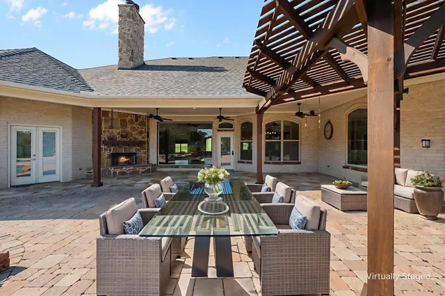 a view of a patio with couches table and chairs and potted plants