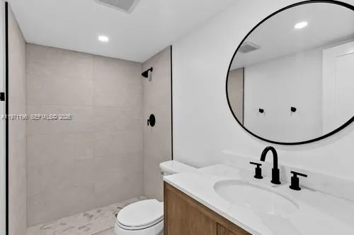a bathroom with a sink toilet and mirror