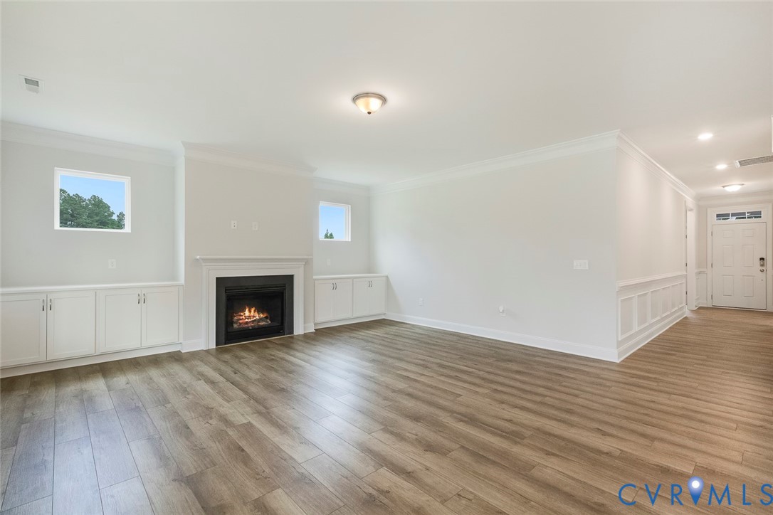 3718 Rocketts Rdg Drive Goochland, VA 23063 - Photo 2 of 13 a view of empty room with wooden floor and fireplace