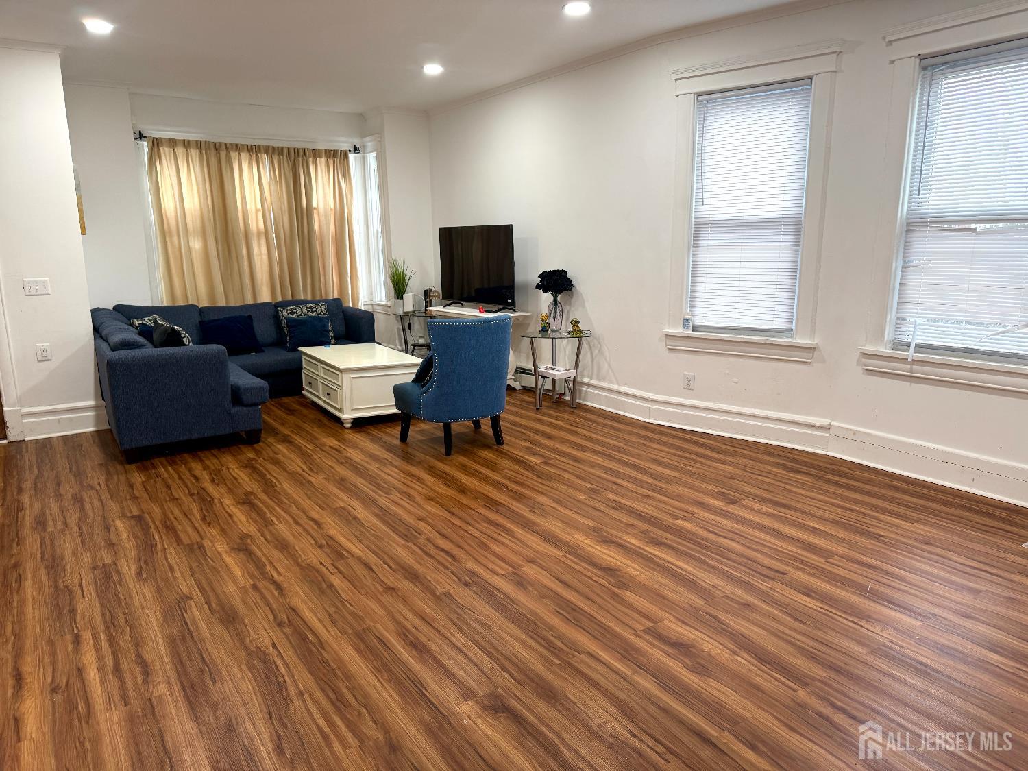 97 Lewis Street, Unit 99 Perth Amboy, NJ 08861 - Photo 2 of 4 a living room with furniture windows and flat screen tv