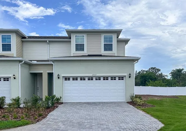 a front view of a house with garage