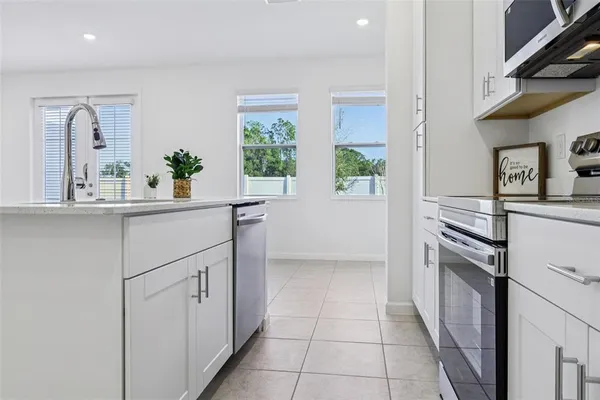 a kitchen with a sink stove and cabinets