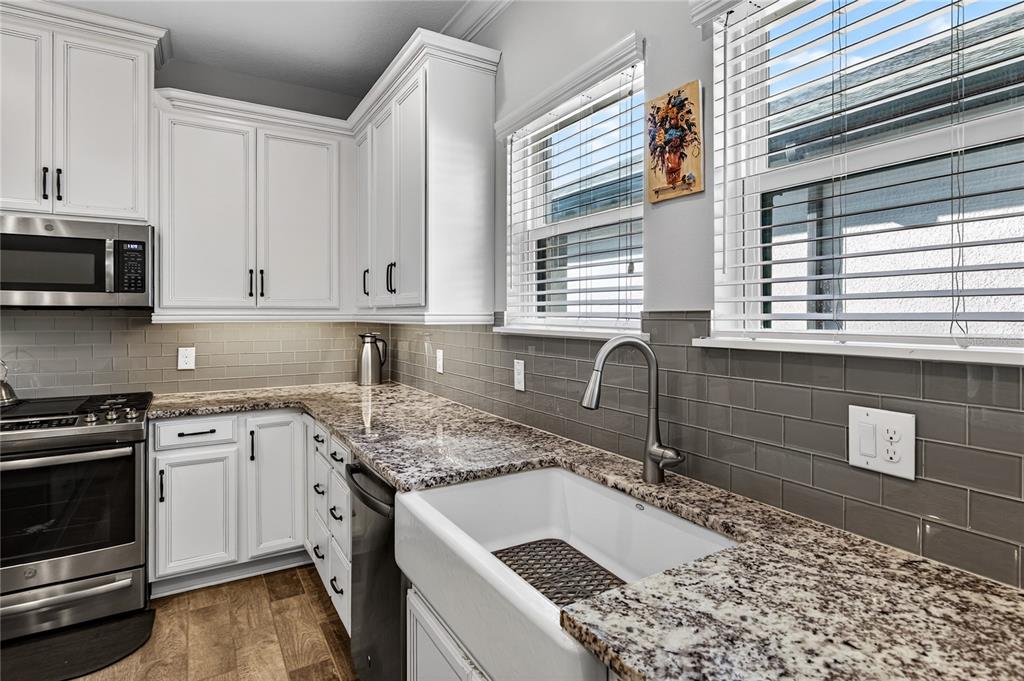 1284 Zeek Ridge Street Clermont, FL 34715 - Photo 11 of 35 a kitchen with a sink stove and cabinets