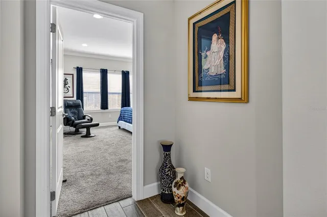a view of a hallway with workspace and bedroom