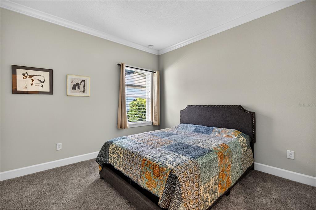 1284 Zeek Ridge Street Clermont, FL 34715 - Photo 20 of 35 a bedroom with a bed and a window