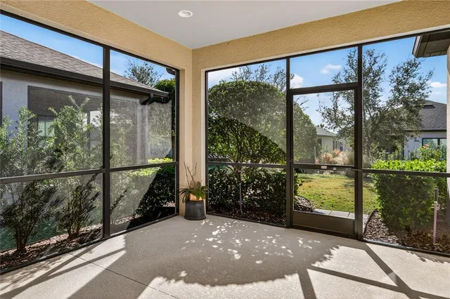 a view of a porch with a floor to ceiling window and tree