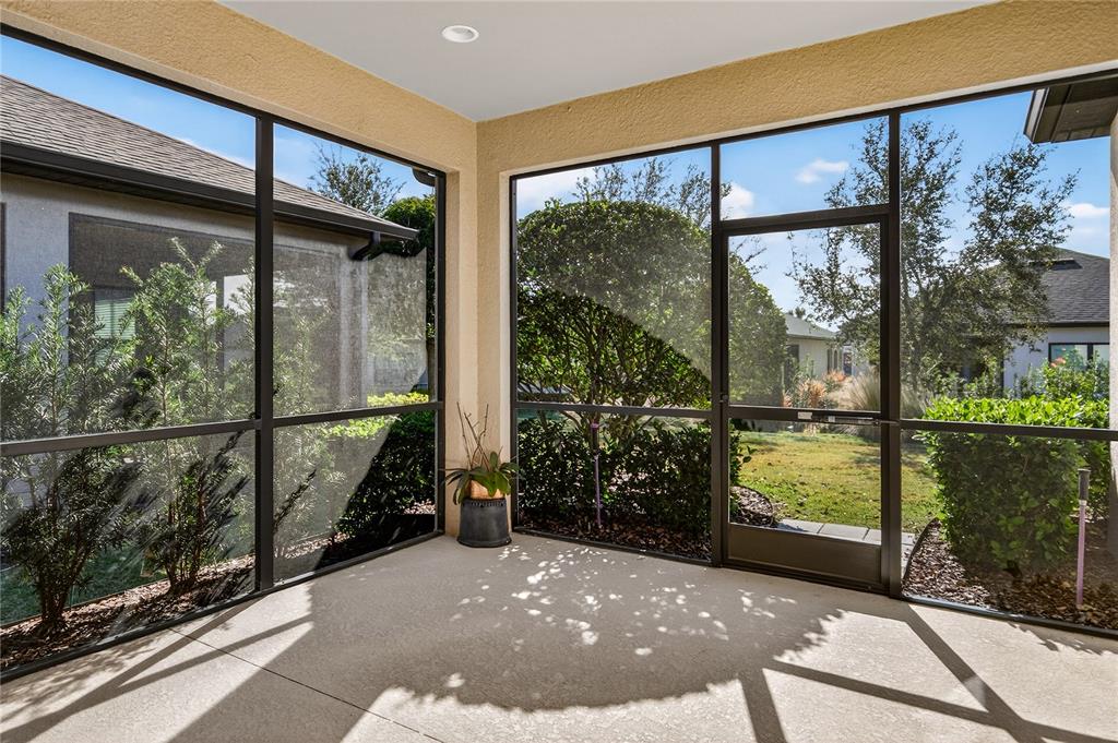 1284 Zeek Ridge Street Clermont, FL 34715 - Photo 24 of 35 a view of a porch with a floor to ceiling window and tree