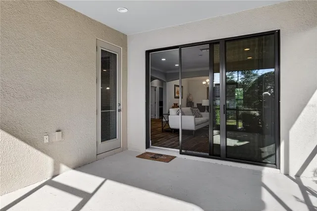 a bedroom with a bed and glass door