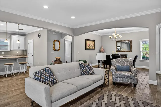 a living room with furniture and wooden floor