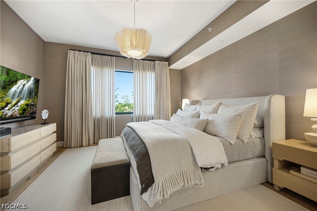 1115 Central Avenue, Unit 443 Naples, FL 34102 - Photo 20 of 40 a spacious bedroom with a bed and a flat screen tv