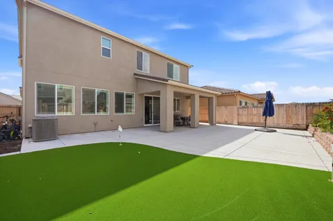 a front view of a house with a yard and porch