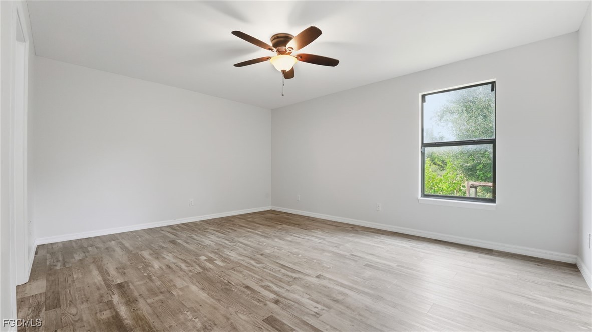 2701 East 18th Street Lehigh Acres, FL 33972 - Photo 4 of 23 an empty room with ceiling fan and window