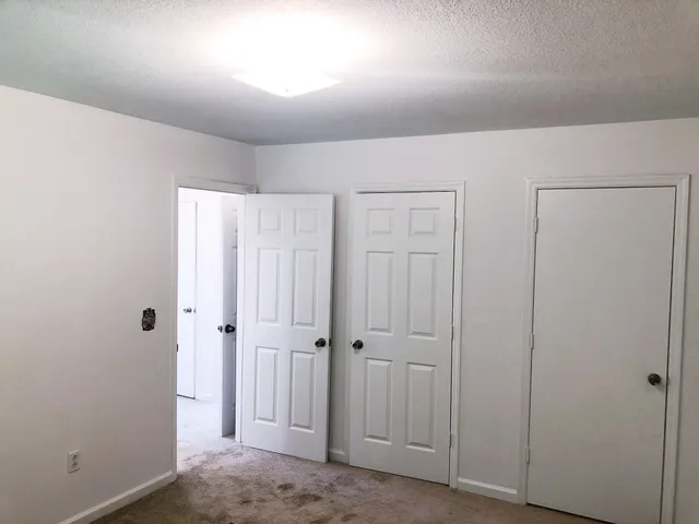 an empty room with closet area