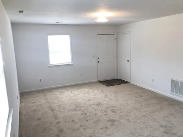 a view of an empty room and a window