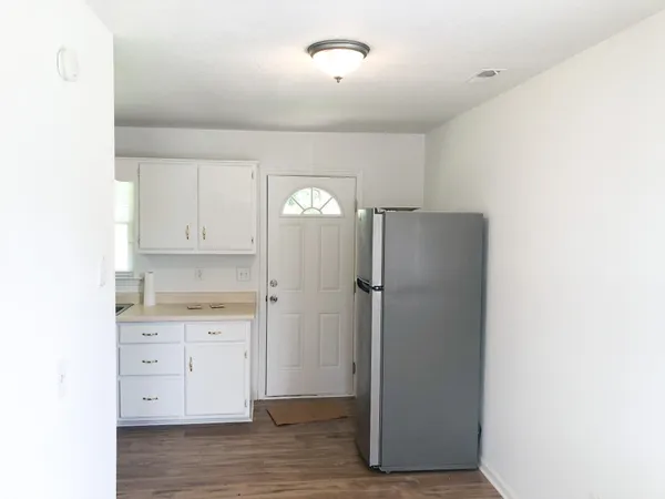 a kitchen with a refrigerator sink and cabinets