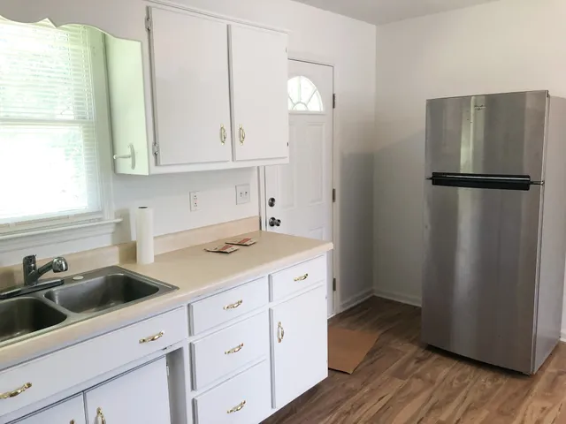 a kitchen with a sink a stove and cabinets