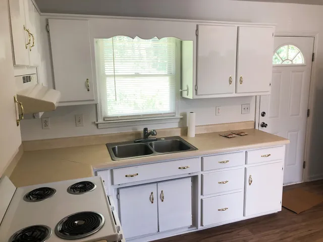 a kitchen with appliances cabinets and a sink