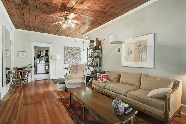 a living room with furniture and wooden floor
