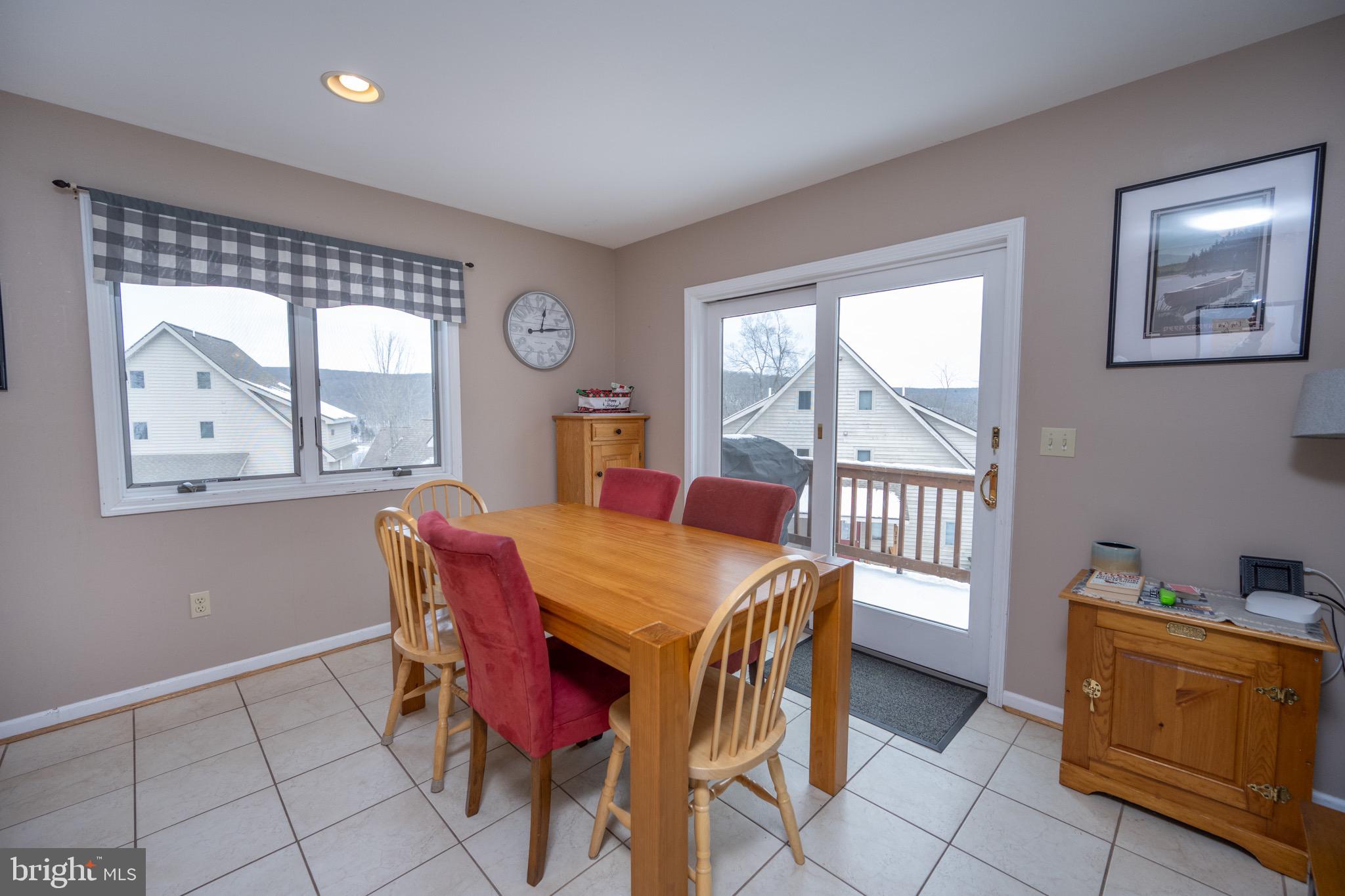 175 Roman Ridge Road, Unit 15 Oakland, MD 21550 - Photo 11 of 53 a view of a dining room with furniture and a window