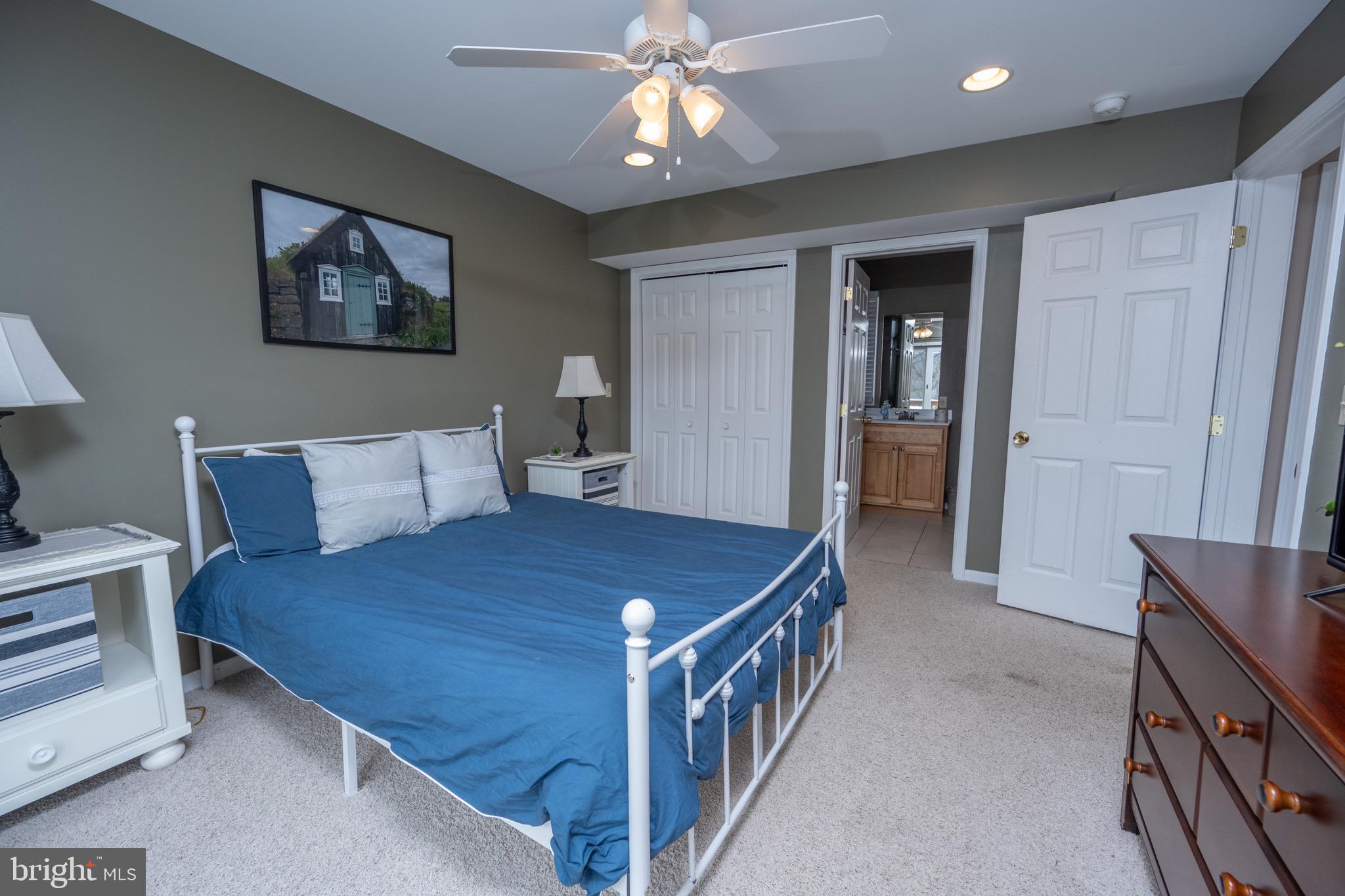 175 Roman Ridge Road, Unit 15 Oakland, MD 21550 - Photo 14 of 53 a bed room with a bed and a chandelier